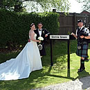 Gretna Green sign and Scottish Piper at Anvil Hall