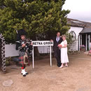 The Gretna Green sign and scottish piper at the World Famous Old Blacksmiths Shop